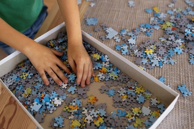 close-up-child-playing-with-puzzle-pieces-min